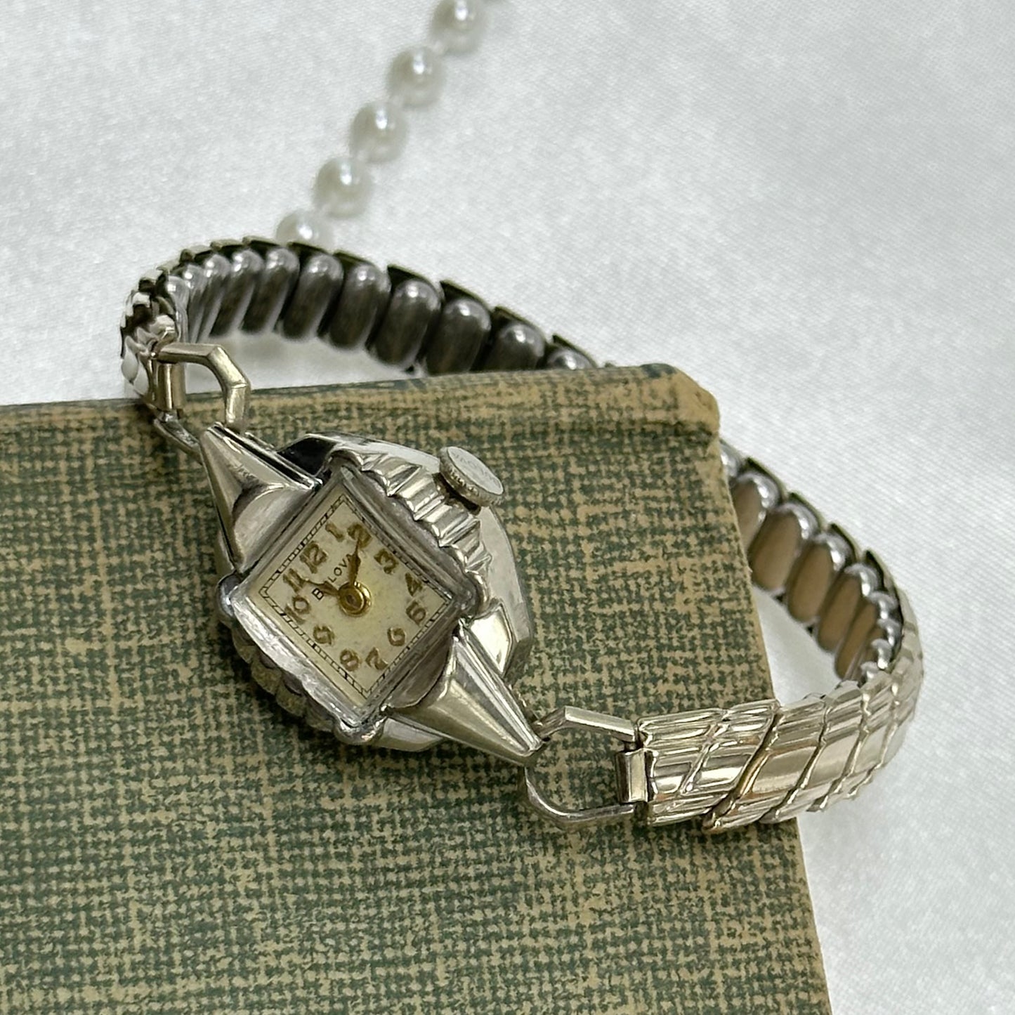 Vintage silver tone Bulova manual winding watch with gold hands and unique stretchable band from the 1950s
