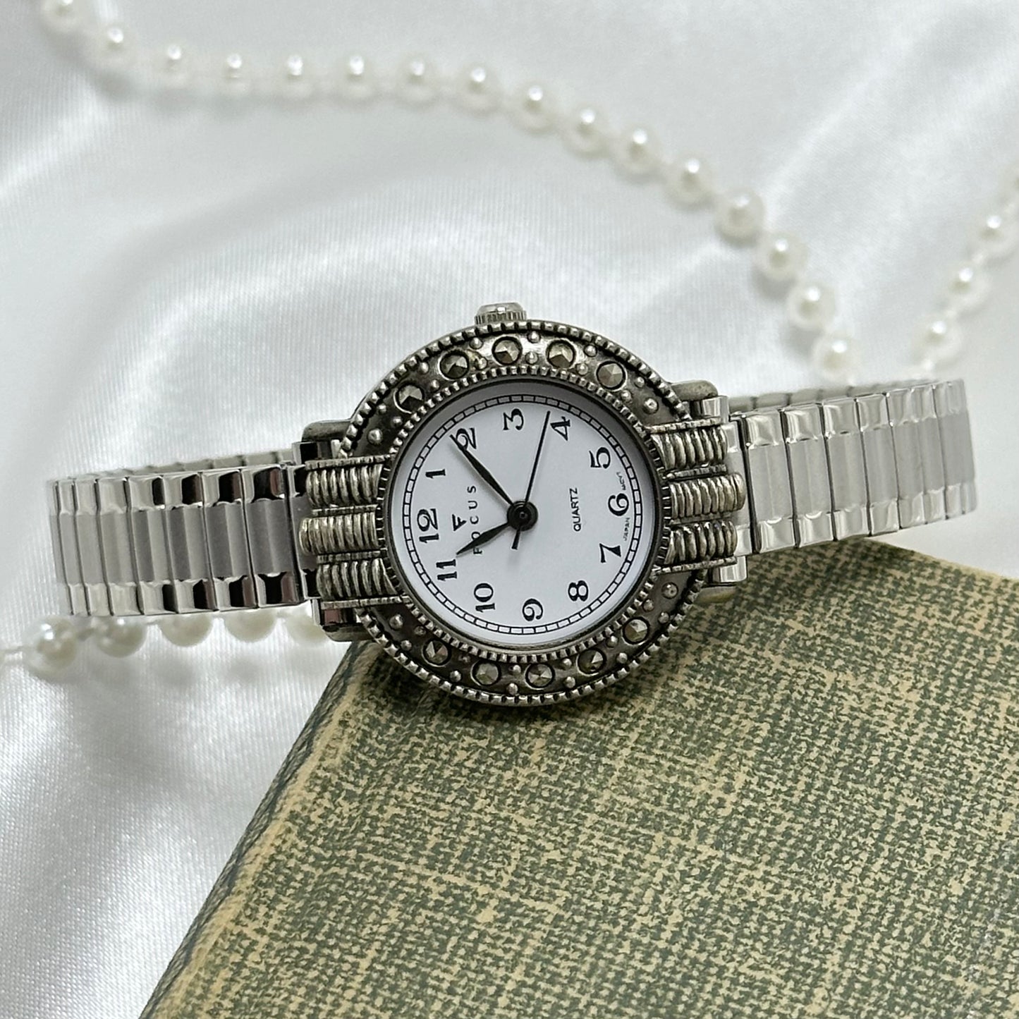 Vintage silver tone Focus watch with marcasite round dial and stretchable band.