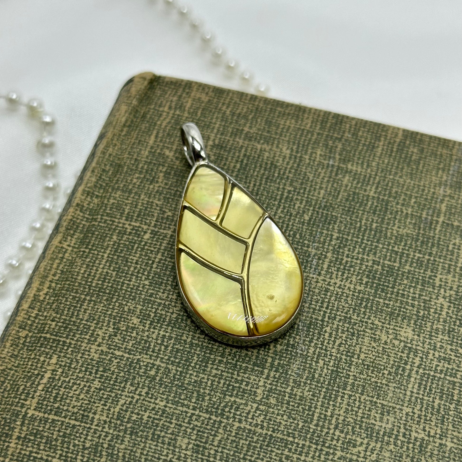 Vintage silver tone Lia Sophia charm pendant.
