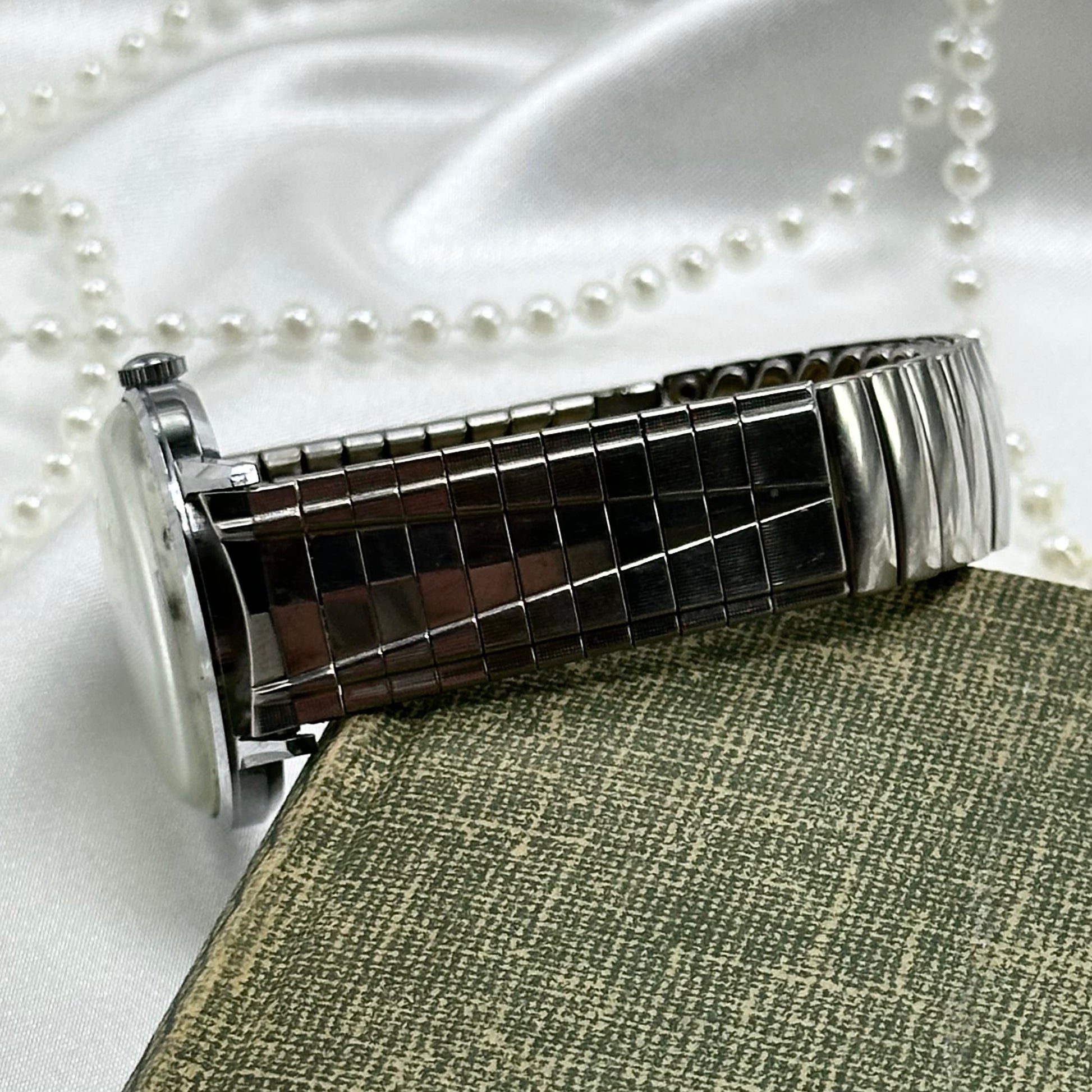 Vintage silver tone Timex manual winding watch with unique stretchable band.