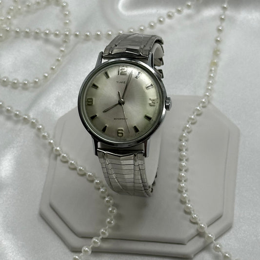 Vintage silver tone Timex manual winding watch with unique stretchable band.