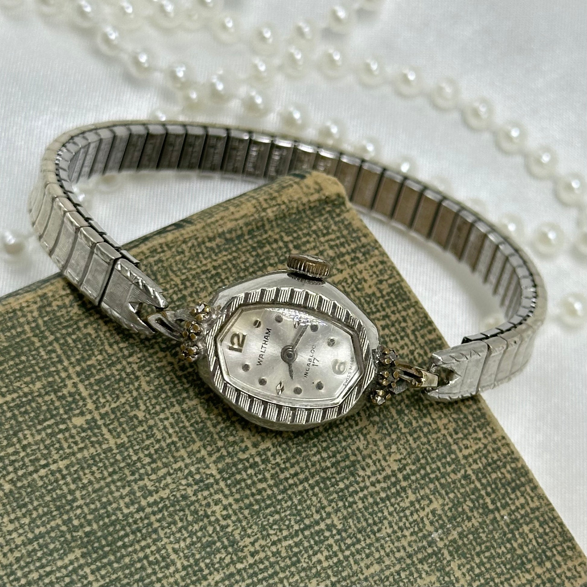 Vintage silver tone Waltham manual winding watch with dainty diamanté dial and stretchable band. Watch comes with original W crown.
