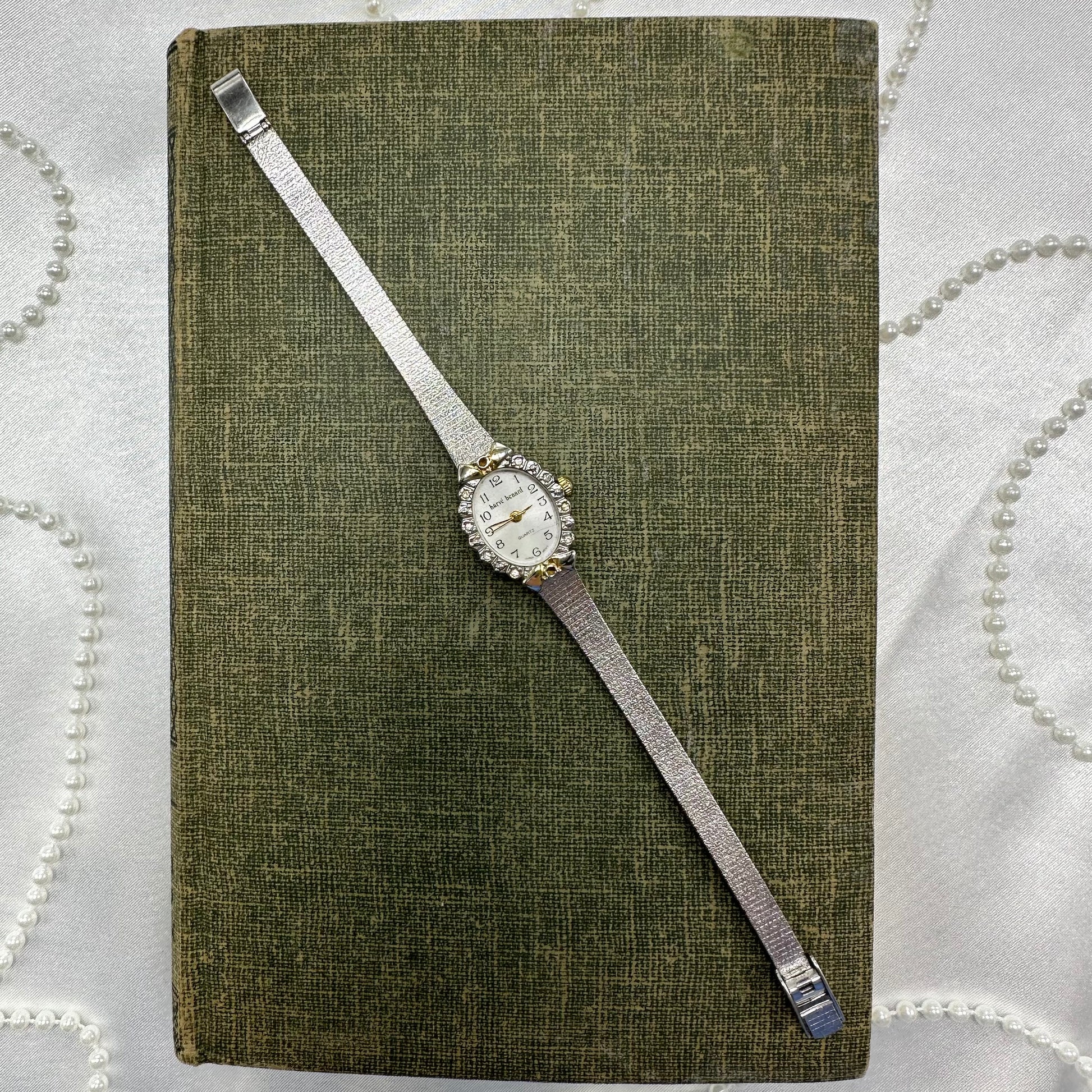 Vintage silver tone diamanté harvé benard watch with gold accents and quartz movement.