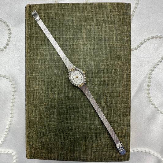 Vintage silver tone diamanté harvé benard watch with gold accents and quartz movement.