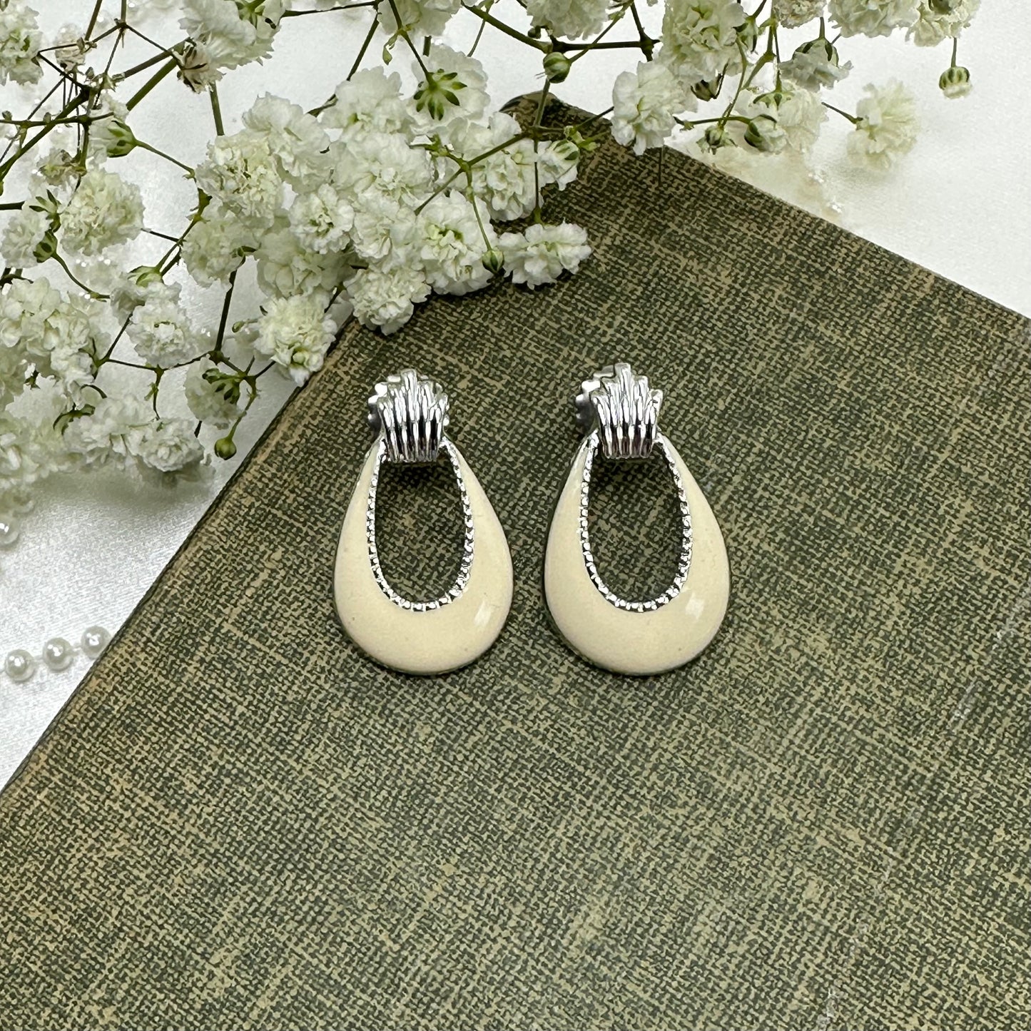 Vintage silver tone drop earrings with cream enamel.