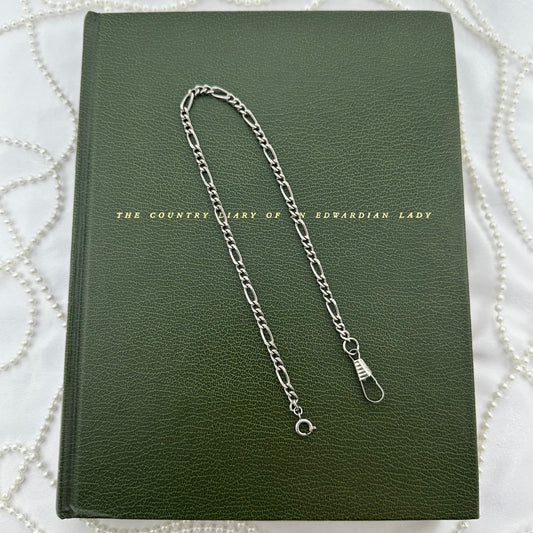 Vintage silver tone figaro watch chain with dog clip clasp.
