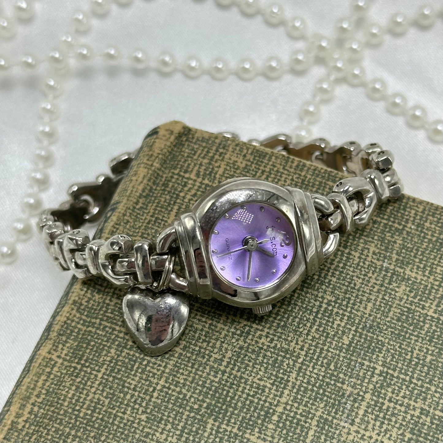Vintage silver tone je-s.com watch with round purple bubble dial and heart charm.