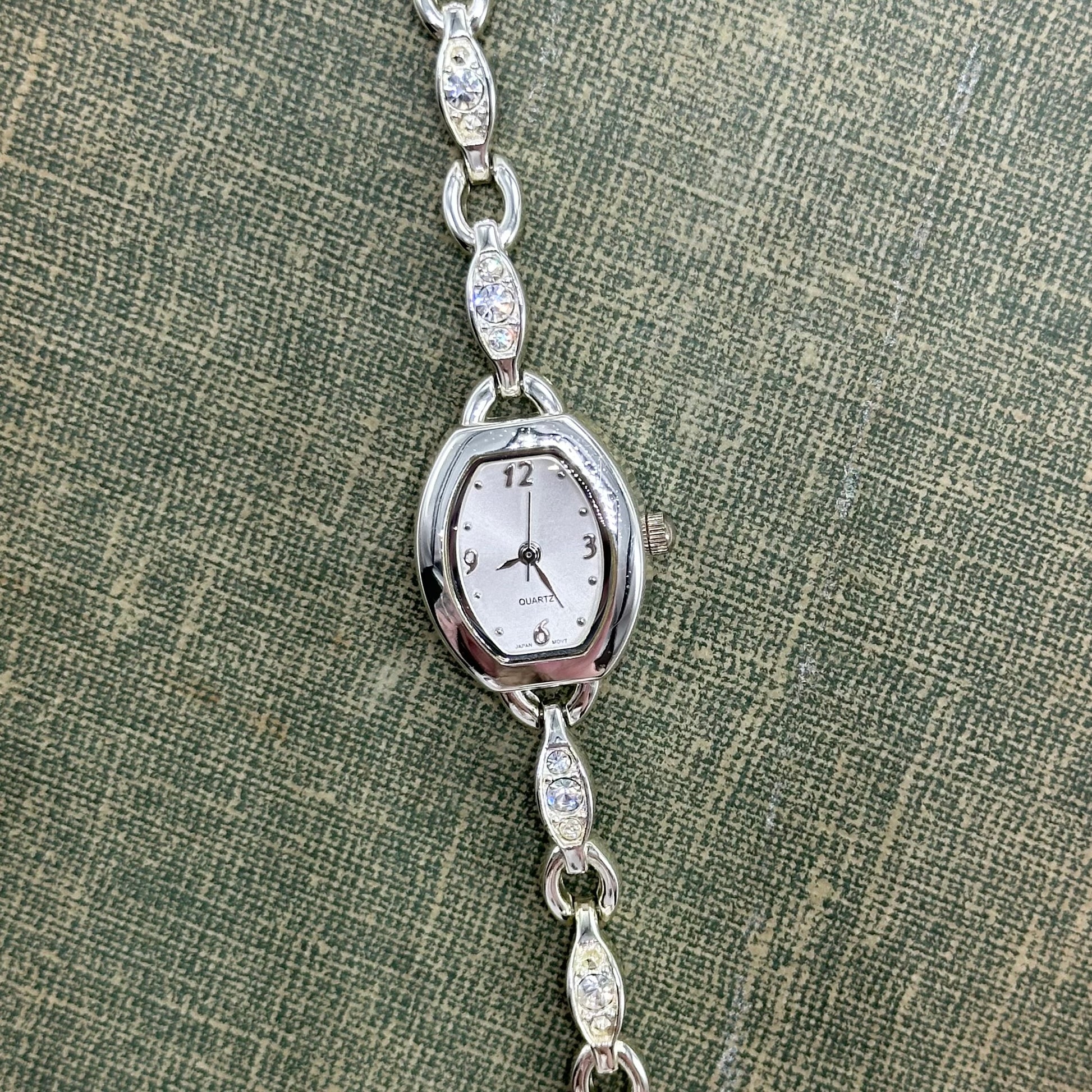 Vintage silver tone watch with elegant diamanté bracelet band and quartz movement.