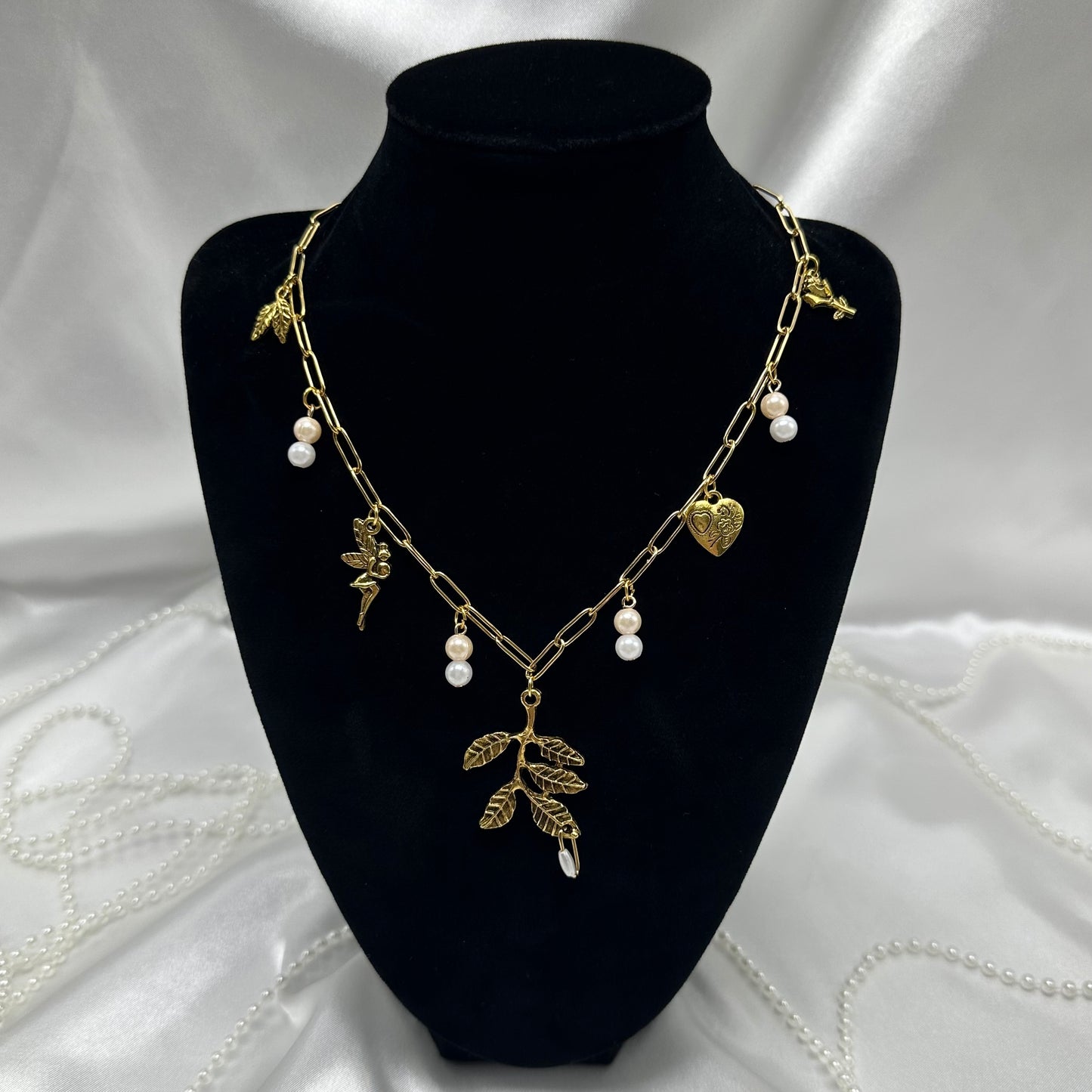 Vintage style gold tone paperclip chain necklace with whimsical fairy charms and faux colored pearls.
